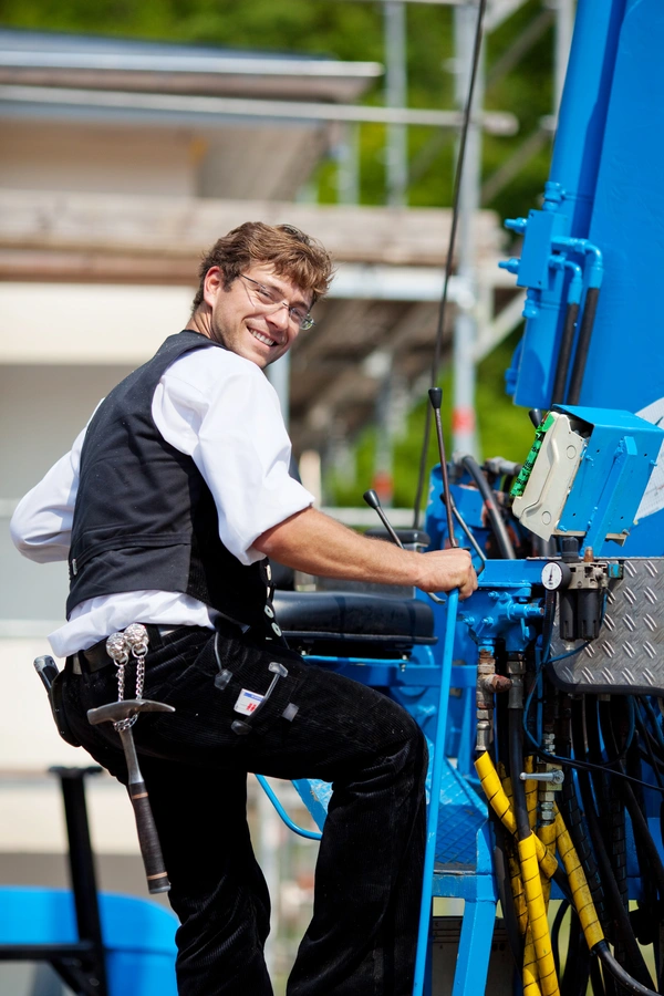 tradesmen operating a crane