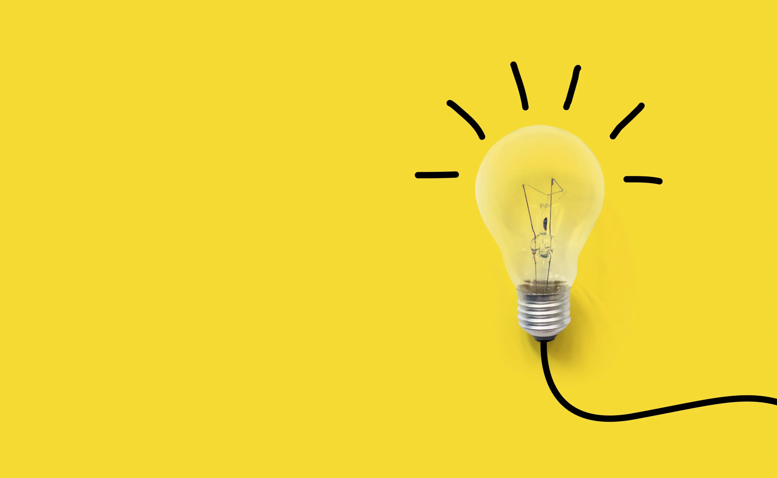 A stock image of a lightbulb against a yellow background