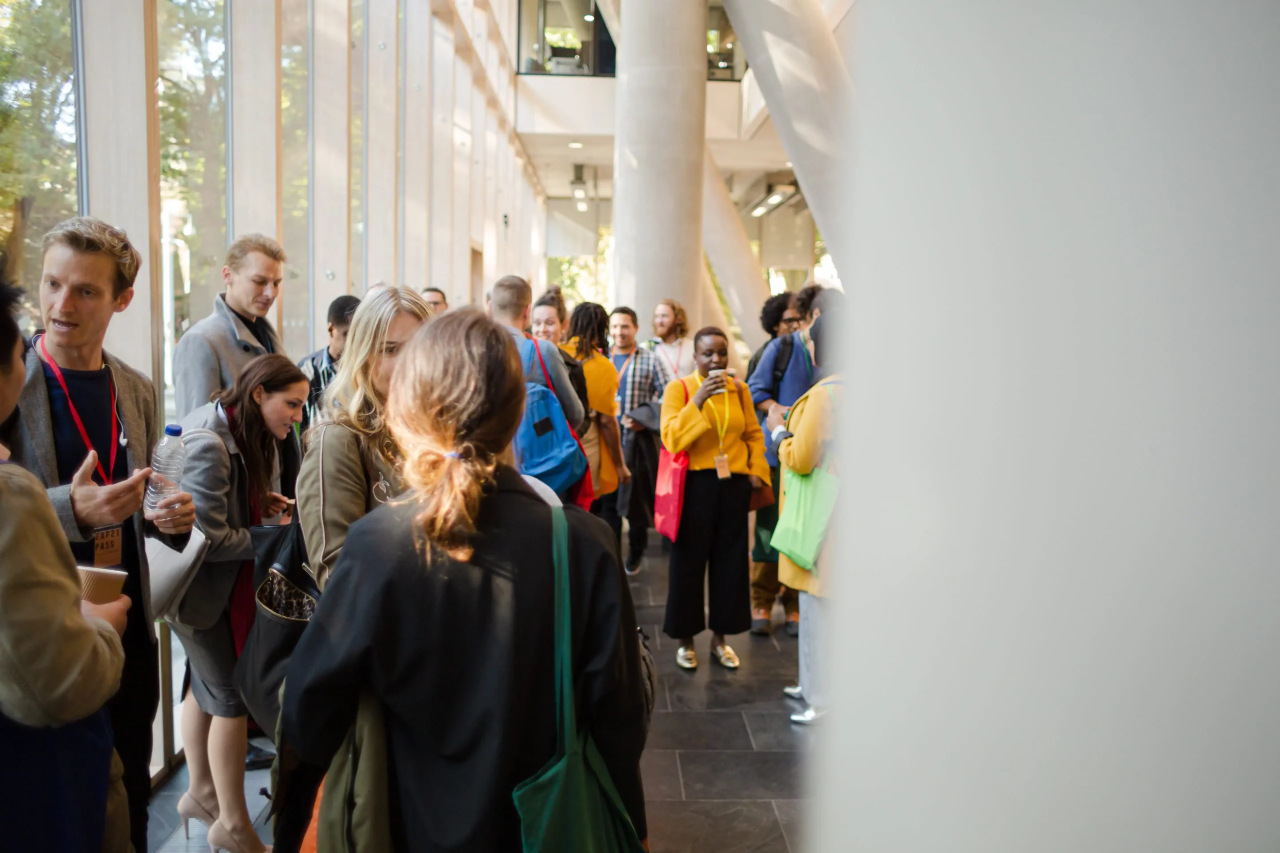 A group of people networking at a market research conference
